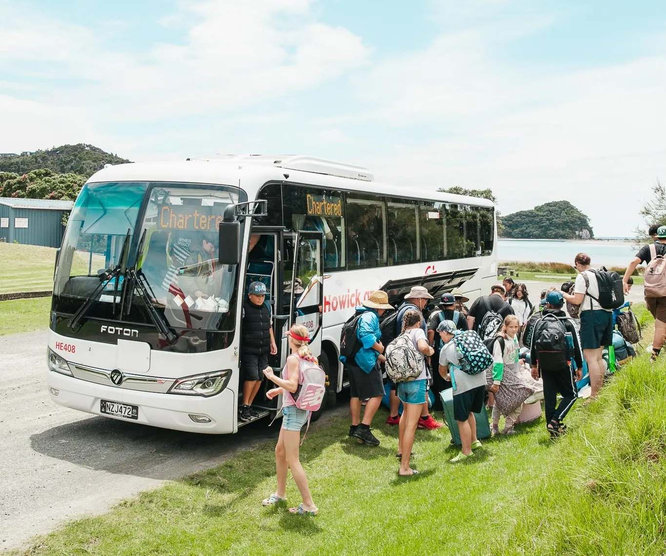 Students step off the charter bus as camp begins