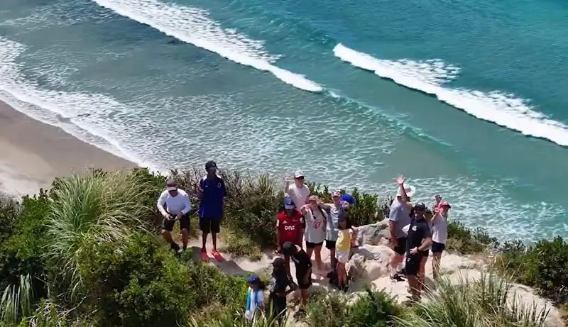 Campers pause above the surf on the coastal exploration walk